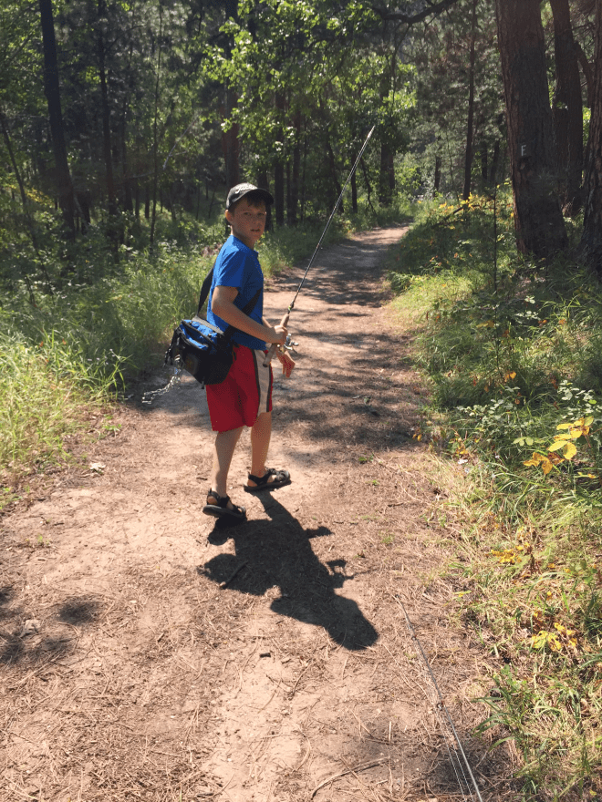 Zack hiking with his fishing gear.